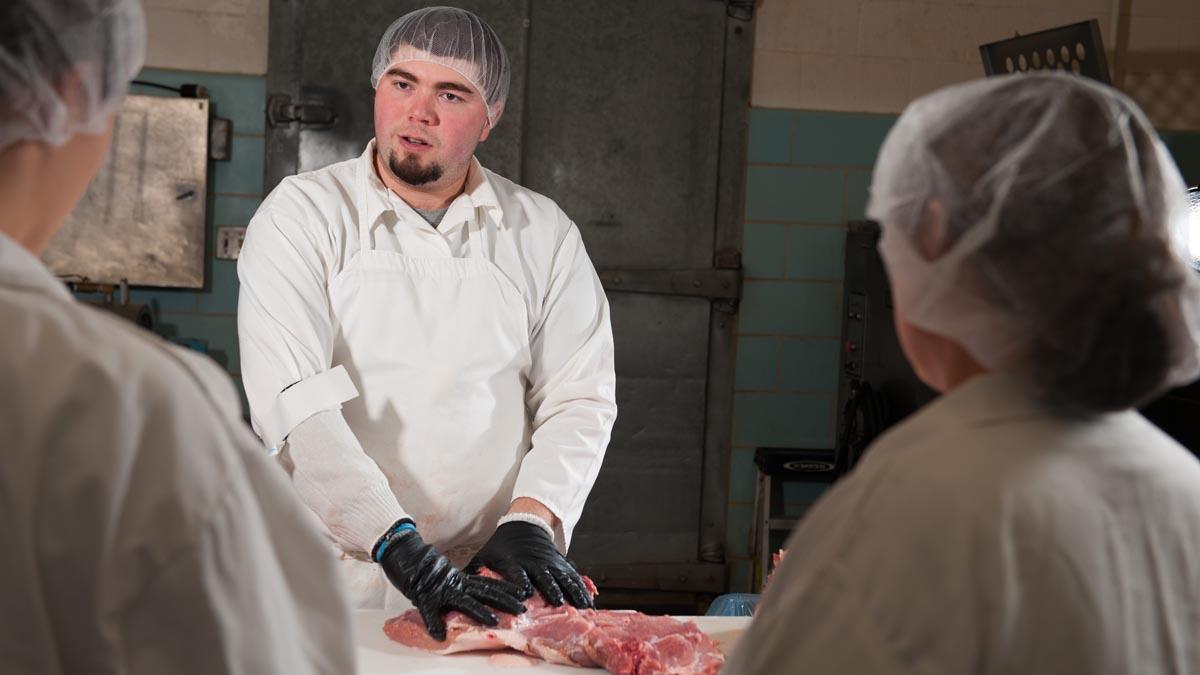 James Nasados teaching students about the cut of meat.